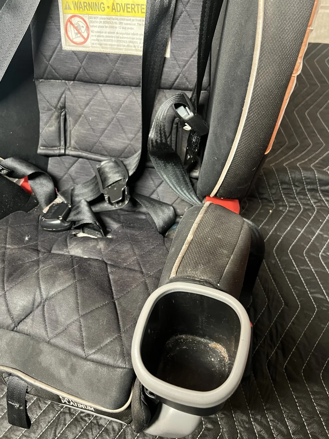 Hidden crumbs and debris in car seat before cleaning